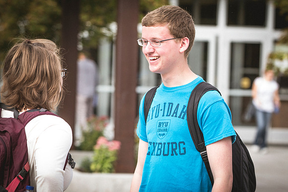 A man and woman talk outside the David O. McKay Library on the first day of school.
