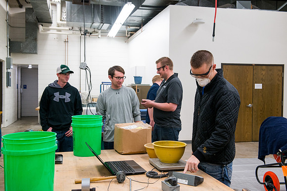 Civil engineering students work with different mixtures of cement to make a light, yet durable, cement that will be the building material for a canoe.