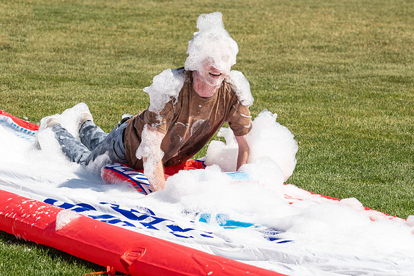Students gather by the upper fields on the BYU-Idaho Campus to play recreation games, slip 'n' slide, mud volleyball, and try the ropes course.