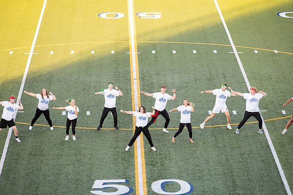Students gather at the stadium to watch the football championship.