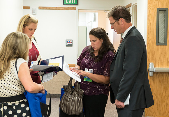 Faculty gather in the Hinckley Building at a Faculty Conference to share and learn from each other at the beginning of the 2013 Fall semester.