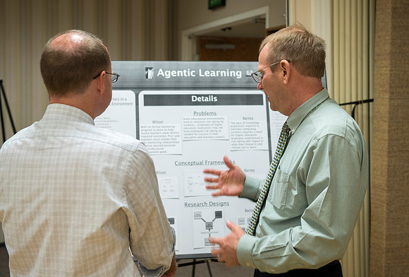 Faculty gather in the Hinckley Building at a Faculty Conference to share and learn from each other at the beginning of the 2013 Fall semester.