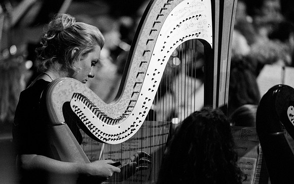 Sacred Music Series: Visions of Eternity. Member of the Choir playing the harp. Performance held in the Hart Auditorium of Ricks College.