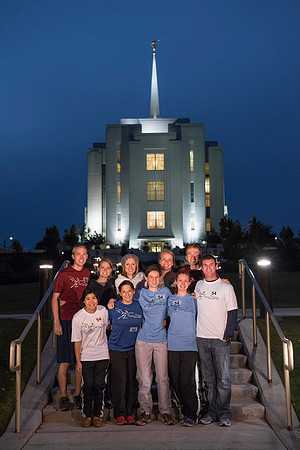 Team members pose by the Rexburg temple before they begin the temple to temple run