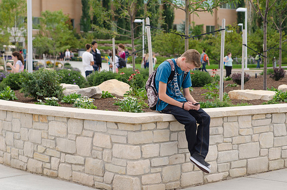 Student texting in between classes