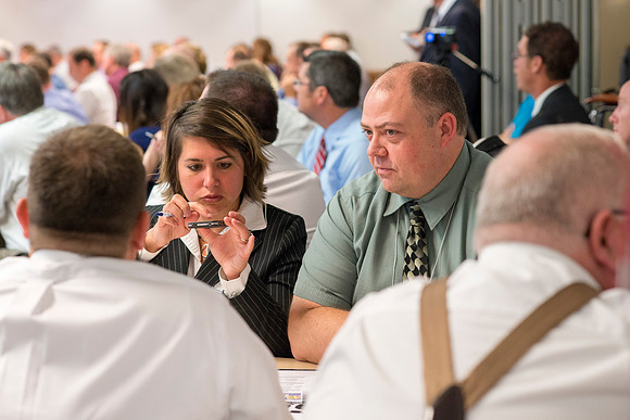 Faculty gather in the Hinckley Building at a Faculty Conference to share and learn from each other at the beginning of the 2013 Fall semester.