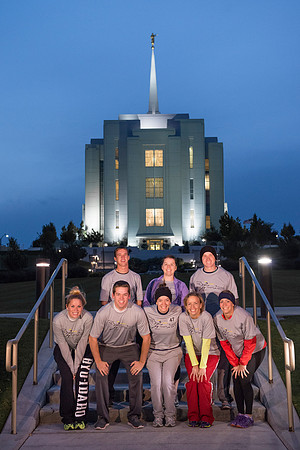Team members pose by the Rexburg temple before they begin the temple to temple run