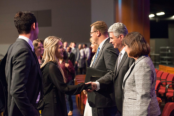 Bishop Gérald Caussé and his wife greet students after devotional.