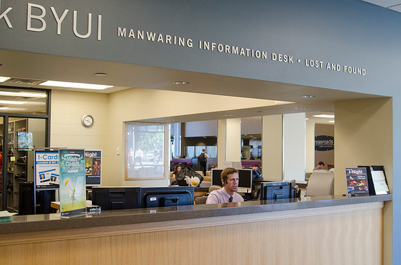 Student employee working at the Manwaring Center information desk