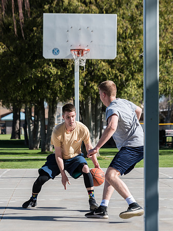 Jacob and Jacob, two BYU-Idaho students, play one on one basketball at the Smith Park court.
