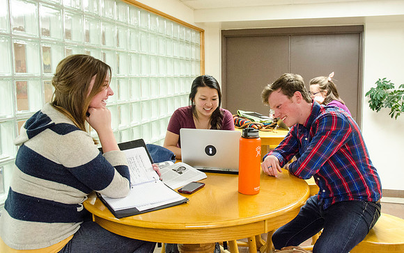 Students studying in the basement of the Benson Building.