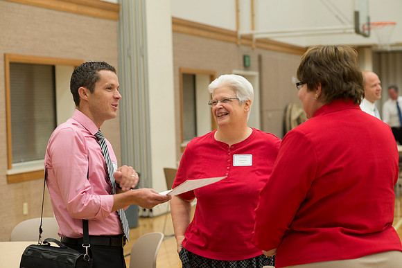 Faculty gather in the Hinckley Building at a Faculty Conference to share and learn from each other at the beginning of the 2013 Fall semester.