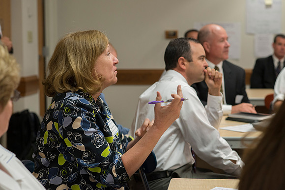 Faculty gather in the Hinckley Building at a Faculty Conference to share and learn from each other at the beginning of the 2013 Fall semester.