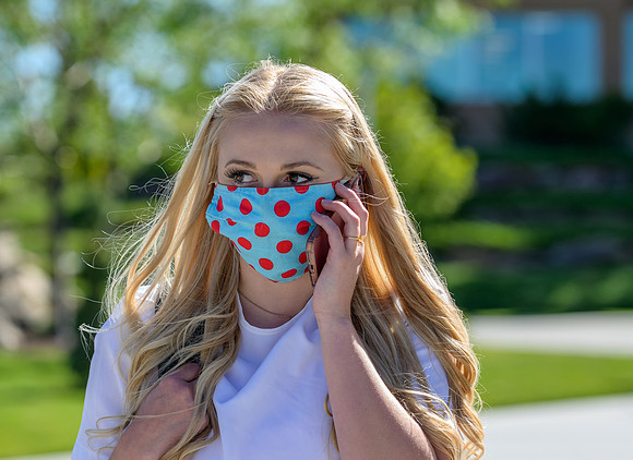 Student volunteers show the way to stay safe during this COVID 19 pandemic by social distancing, following pathway arrows and proper wearing of masks .