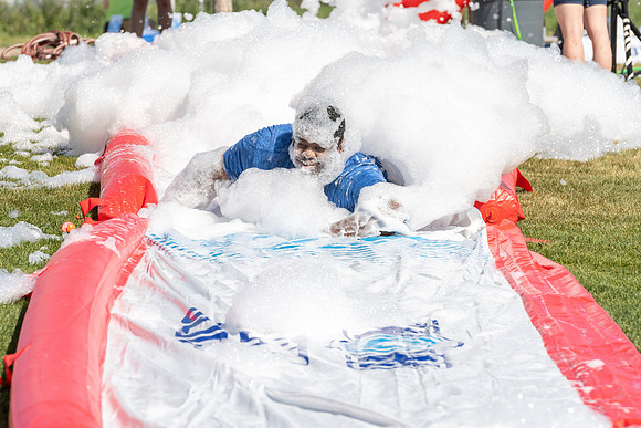 Students gather by the upper fields on the BYU-Idaho Campus to play recreation games, slip 'n' slide, mud volleyball, and try the ropes course.
