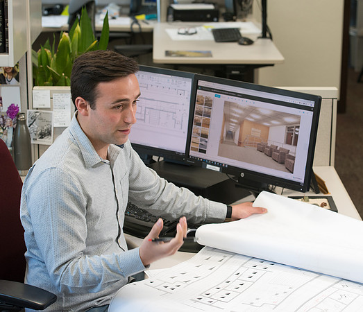Sterling Kreutzer, a Construction Management major working with architectural drawings and 3D design at the University Operations Facility.