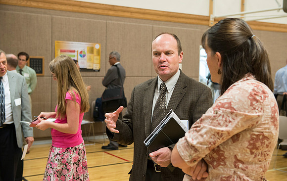 Faculty gather in the Hinckley Building at a Faculty Conference to share and learn from each other at the beginning of the 2013 Fall semester.