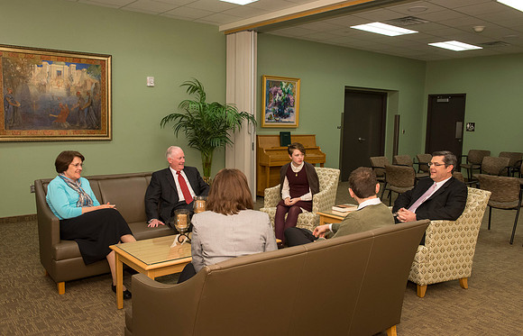 Behind the scenes of devotional, President and Sister Clark visits with guests before going out on stage.