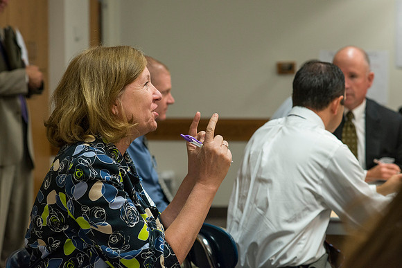 Faculty gather in the Hinckley Building at a Faculty Conference to share and learn from each other at the beginning of the 2013 Fall semester.