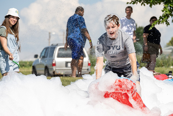 Students gather by the upper fields on the BYU-Idaho Campus to play recreation games, slip 'n' slide, mud volleyball, and try the ropes course.