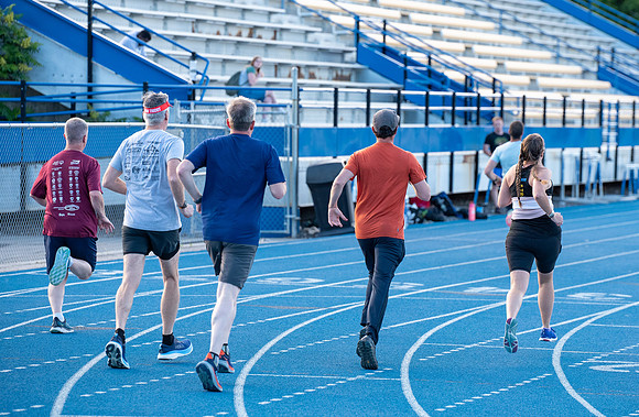 Faculty and community members of BYUI at Speed and Agility triathlete trannings at the stadium.