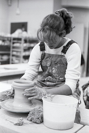 Art student works diligently on a piece of pottery for Ceramics class.