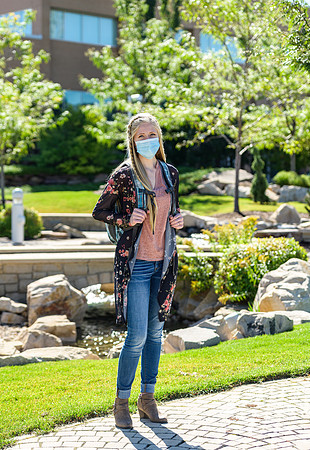 Student volunteers show the way to stay safe during this COVID 19 pandemic by social distancing, following pathway arrows and proper wearing of masks .