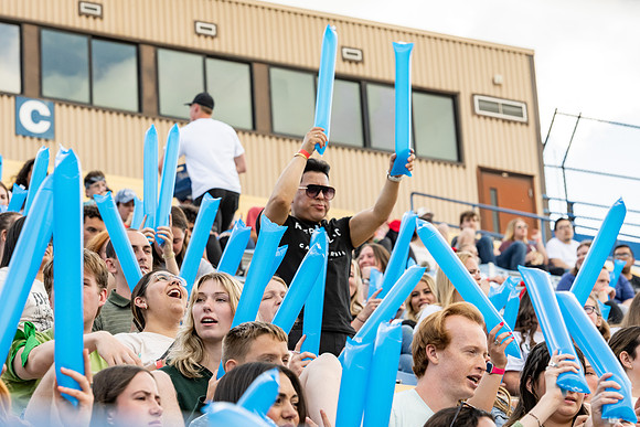 Students gather at the stadium to watch the football championship.