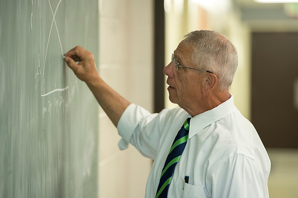 Brother Kerry Webb discusses with his class, the importance of understanding the past and future of the US economy.