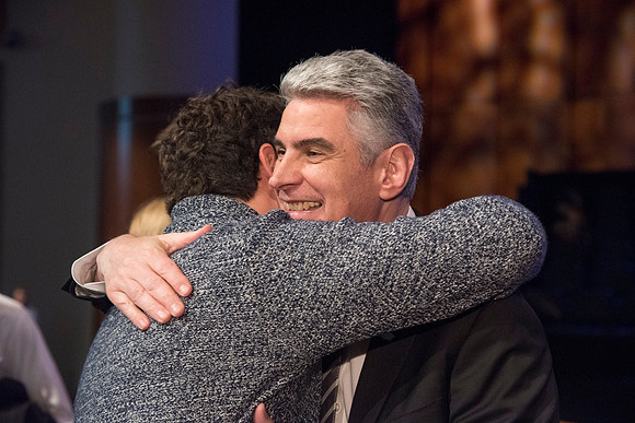 Bishop Gérald Caussé, hugs his friend, Matias Costa, after Bishop Caussé's devotional address at BYU-Idaho. Photo by Ryan Chase