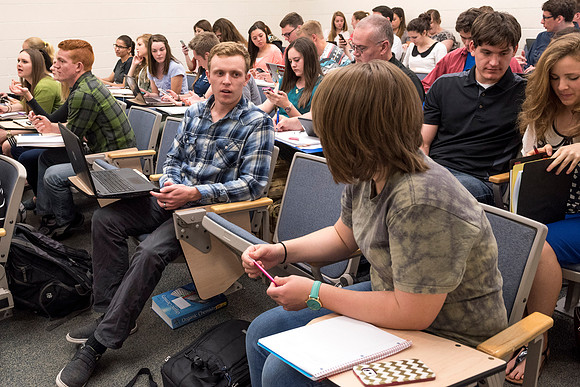 Students working with each other in the Foundations of the Restoration course on campus.
