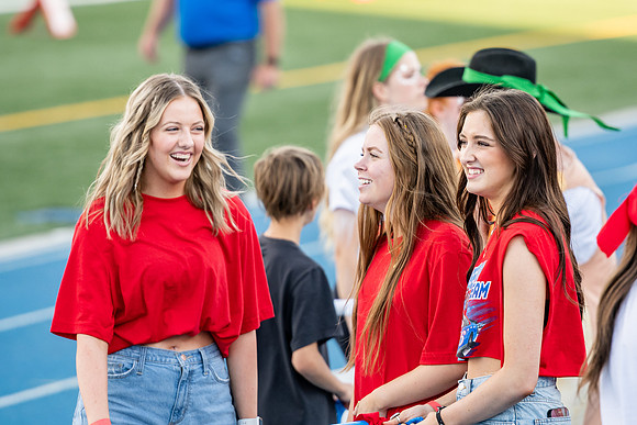 Students gather at the stadium to watch the football championship.