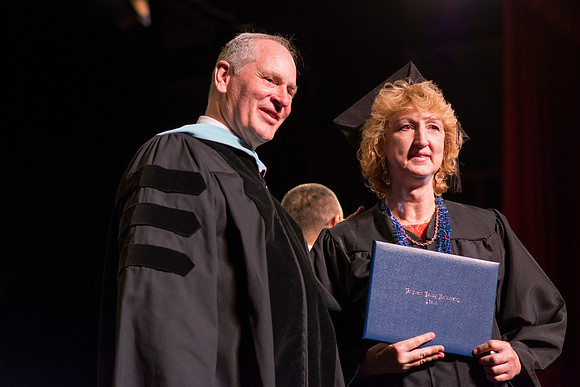 Almost 20% of those who graduated were online students.  (Ric Page and graduate at the Interdisciplinary Studies Convocation)