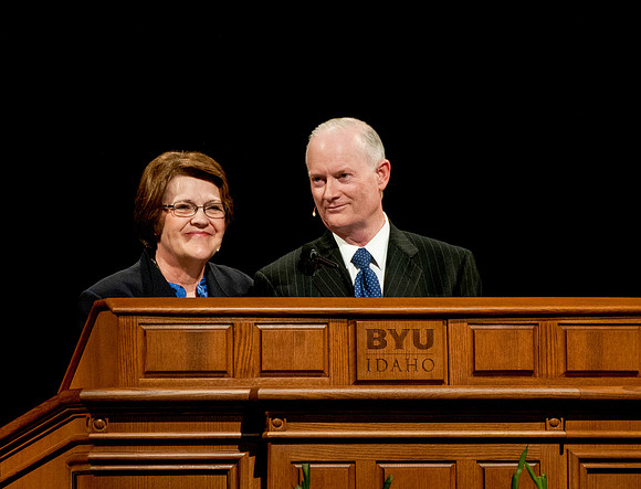 President and Sister Clark speak together during a devotional