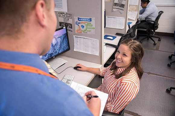 Employees work on developing a better curriculum for online students.