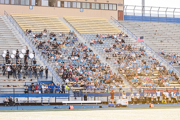 Students gather at the stadium to watch the football championship.
