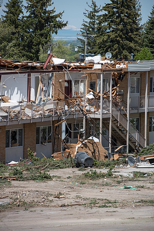 Construction workers work at tearing down the old campus dorms for a new campus project.