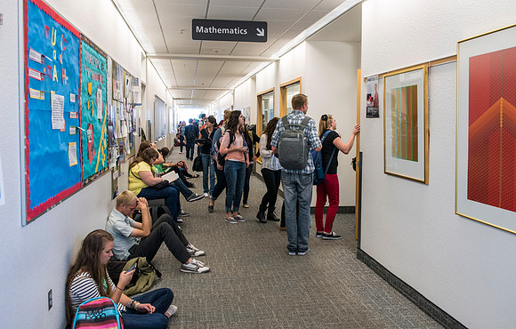Students patiently waiting for the changing of the classes the hallway in the Ricks Building outside the Mathematics classrooms gets a little crowded.