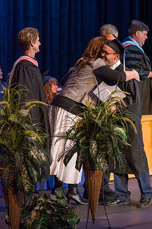 BYU-Idaho graduates accepting their diploma covers at convocation for the College of Perfoming and Visual Arts. Photo by Ryan Chase