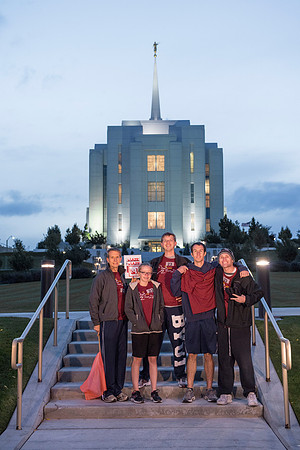 Team members pose by the Rexburg temple before they begin the temple to temple run