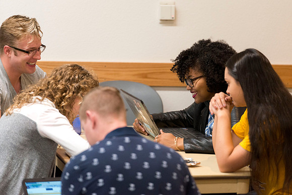 Students talk in groups about the discussion: deviating from the norm and the effect it can have on society.