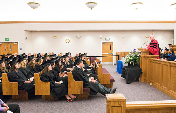 Elder Kim B. Clark, Commissioner of Church Education, shares his remarks and congratulates students as they receive their diplomas.