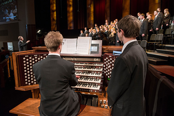 Randall Kempton rehearses with the Collegiate Singers in the BYU-Idaho Center before devotional.