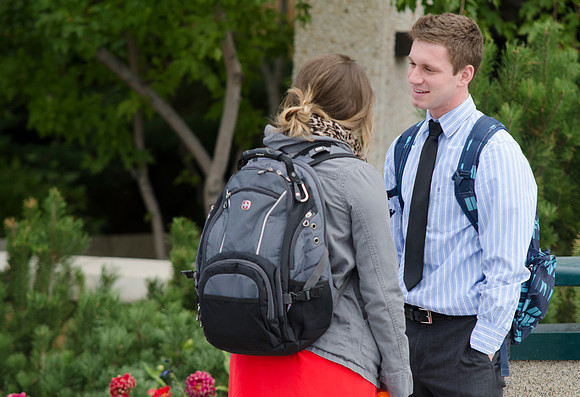 Students stop to talk to each other between classes