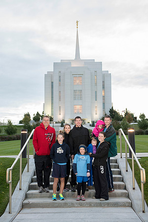 Team members pose by the Rexburg temple before they begin the temple to temple run