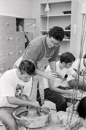Rich Briggs helps a student as creates his piece of pottery.
