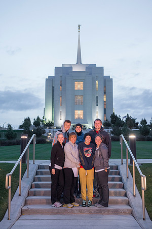 Team members pose by the Rexburg temple before they begin the temple to temple run