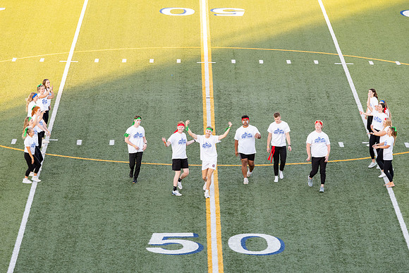 Students gather at the stadium to watch the football championship.