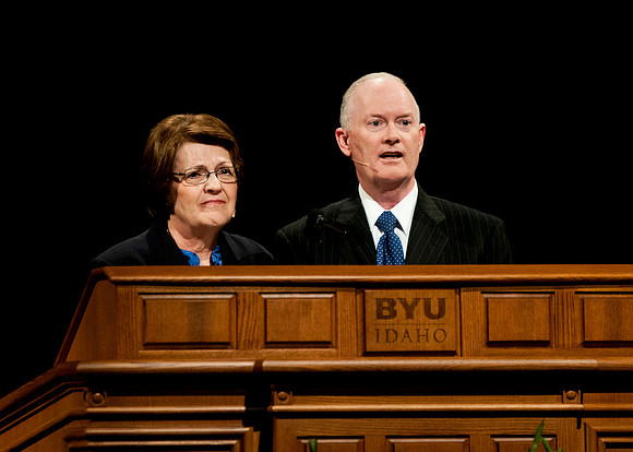 President and Sister Clark speak together during a devotional