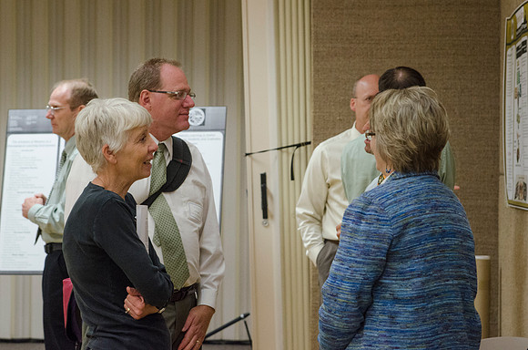 Faculty members talking together at the faculty meeting Fall 2013